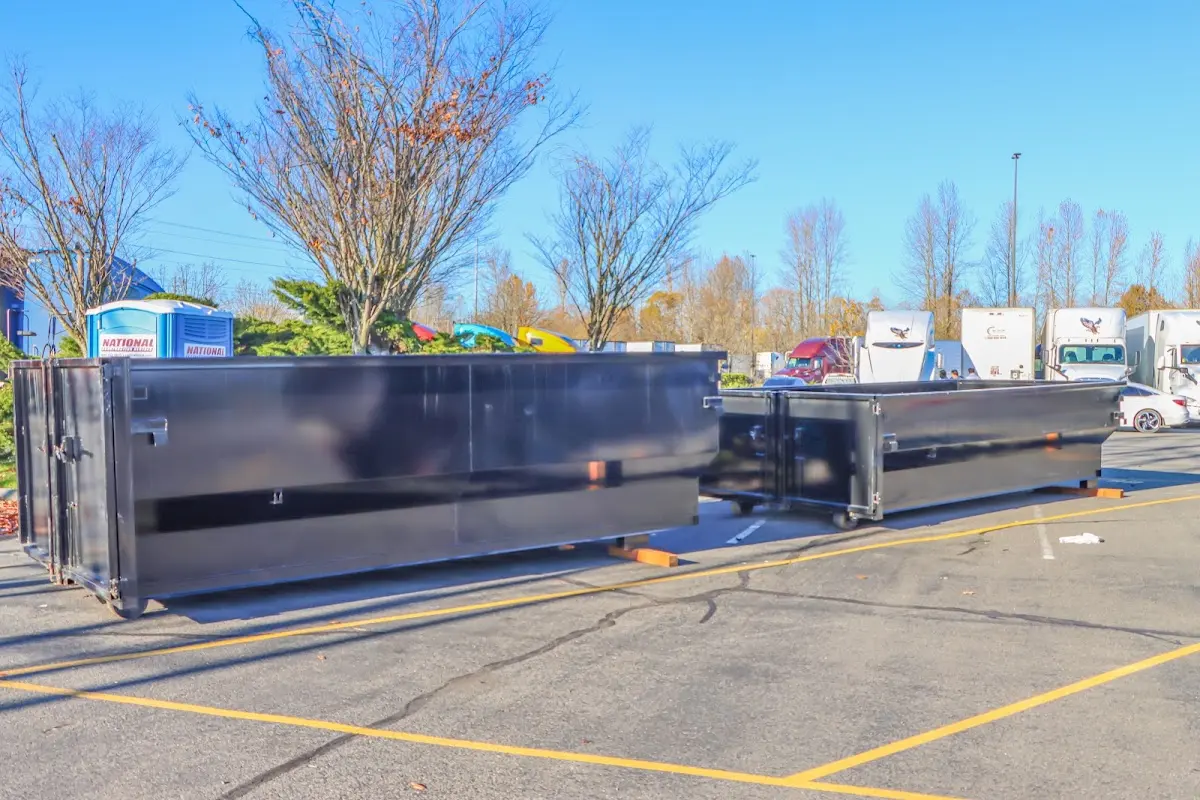 Professional dumpster rental service with roll-off container on residential driveway in Madras